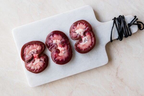 Sliced Raw Lamb Kidney on Marble Board.