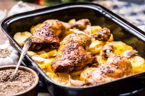 Roasted chicken leg with potatoes with caraway and garlic