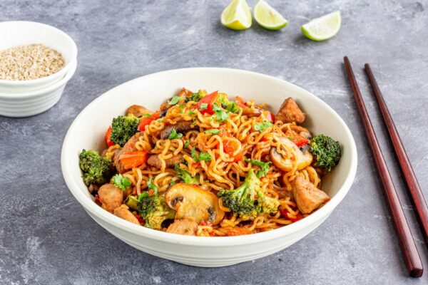 Ramen Noodles with Broccoli, Bell Pepper and Chicken in a Bowl with Chopsticks